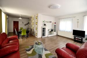 a living room with a couch and a table at Zöld Apartmanház in Balatonboglár