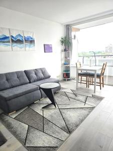 a living room with a couch and a table at City View in Offenbach
