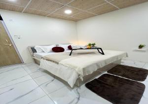 a bedroom with a bed with a table on it at Sizzle Bay Resort in Pune