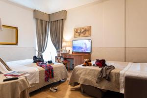 Postel nebo postele na pokoji v ubytování Hotel Ambasciatori