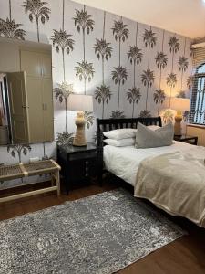 a bedroom with two beds and a mirror and a rug at Chakas One in Ballito