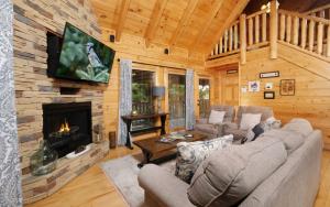 a living room with a fireplace in a log cabin at Rockin in the Smokies in Pigeon Forge