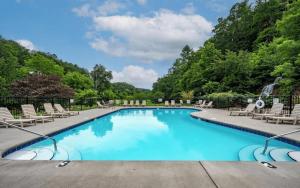 a swimming pool with chairs and a waterfall at Rockin in the Smokies in Pigeon Forge