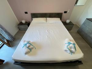 a bed with shoes on it in a room at Baleari House in Termoli
