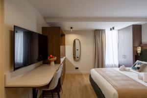 a hotel room with a large bed and a desk at Sol St Mande - 2 pers- 32 in Saint-Mandé