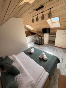a bedroom with a large bed with two pillows on it at *Studio David* in Sibiu