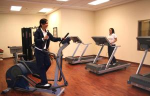 a woman riding on an exercise bike in a gym at Safi Royal Luxury Valle in Monterrey