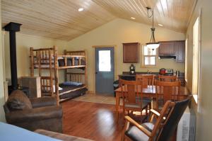 a kitchen and dining room with a table and a dining room at Homestake Lodge in Whitehall