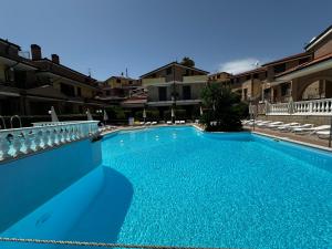 a large blue swimming pool in a building at La Piazzetta in Tortoreto Lido +12 photos