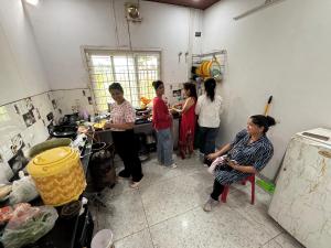 a group of people standing in a kitchen at Mountain Valley in Jhājra