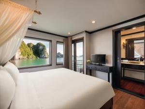 a bedroom with a large bed and a window at Amanda Premier Cruise Ha Long in Ha Long