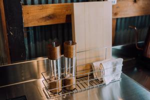 a kitchen counter with two wooden sticks in a drying rack at Ivy Harajuku in Tokyo +110 photos
