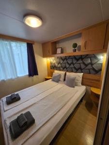 a bedroom with a large bed with towels on it at Sára Vendégház 2 in Szentes