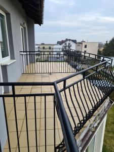 a balcony with a black railing on a building at Willa Helios in Władysławowo