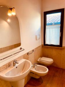 a bathroom with a sink and a toilet and a mirror at Maison Mavino in Desenzano del Garda +127 photos
