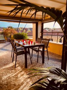 a table and chairs in a patio with a view at Maison Mavino in Desenzano del Garda
