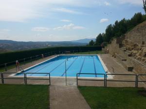 a large blue swimming pool with people standing around it at Hospedería Prepirineo in Undués-Pintano