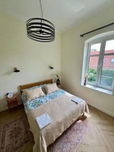 Postel nebo postele na pokoji v ubytování Apartament Frombork Łempicka