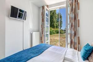 Ein Bett oder Betten in einem Zimmer der Unterkunft Residenz am Balmer See - BS 37H mit Wellnessbereich