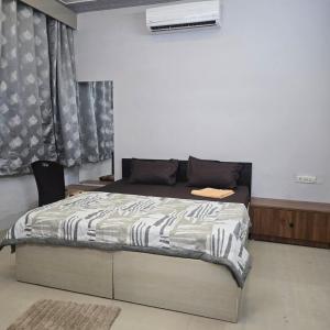 a bedroom with a bed in a room at Satyabhama Homestay-Sapphire- two bhk Luxury appartment in Indore