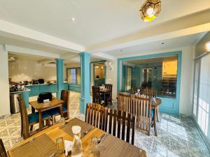 a restaurant with wooden tables and chairs and a dining room at Hotel Pashm Home in Srinagar