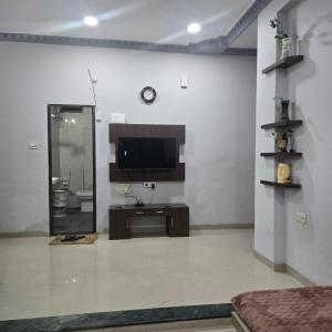 a living room with a flat screen tv on a wall at Satyabhama Homestay-Sapphire- two bhk Luxury appartment in Indore