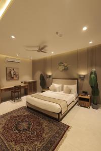 a bedroom with a large bed and a rug at Balaji Seven Hills in Jaipur +16 photos