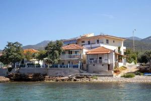 a house on the shore of a body of water at Manolis Studios Thassos in Skala Kallirachis