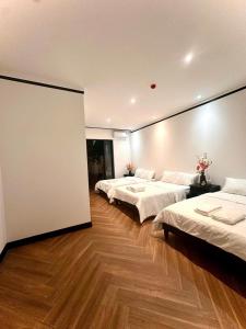 a room with two beds and a large wall at Mia Garden Hotel in Dinh Ðiền Buôn Hô