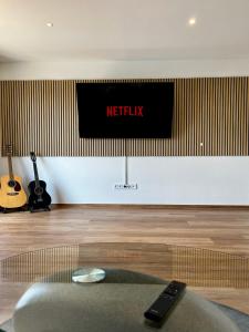 a netflix sign on a wall in a room at Deluxe Apartment in Jettingen-Scheppach