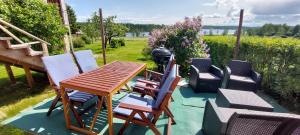 a group of chairs and a table on a patio at Djurstagården Hälsingegård in Jättendal +26 photos