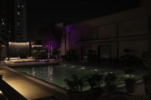 a swimming pool at night on a building at Balaji Seven Hills in Jaipur