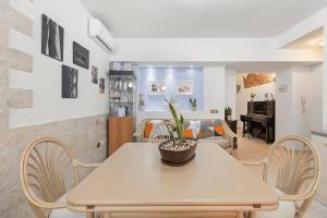 a dining room and living room with a table and chairs at Dimora del Chiostro in Oristano