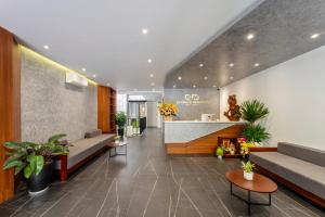 a lobby of a hospital with couches and plants at Em's House Hoi An Homestay 2 in Hoi An