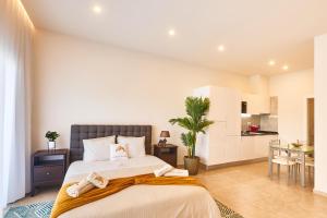 a bedroom with a large bed and a kitchen at Apartamento Praia Santa Maria in Santa Maria +19 photos