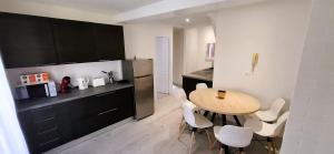 a kitchen with a table and a small kitchen with a counter at Le Central in Villeneuve-sur-Yonne