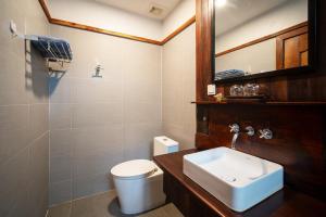 a bathroom with a white toilet and a sink at Domnak Pichet in Siem Reap