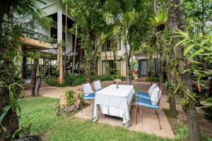 a table and chairs in front of a building at Domnak Pichet in Siem Reap