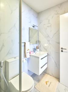 a bathroom with a toilet and a sink and a mirror at Apartamento Praia Santa Maria in Santa Maria