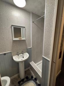 a bathroom with a sink and a shower and a toilet at Affordable Golden Mile Hotel In Blackpool Close To The Beach And Blackpool City Centre in Blackpool