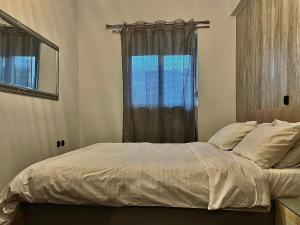 a bedroom with a large bed with a window at Valla Studio in Rhodes Town +20 photos