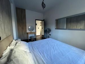 a bedroom with a large bed and a fan at Valla Studio in Rhodes Town