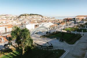 a view of a city with buildings and palm trees at Bairro Alto Suites in Lisbon +21 photos