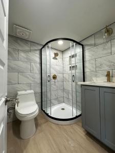 a bathroom with a shower and a toilet and a sink at Tiny Private Room #4 in Shared 5BR House with Other Guests in Austin