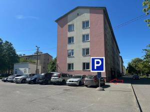a parking lot with cars parked in front of a building at Tallinn Randla 14 in Tallinn