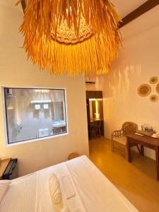 Un pat sau paturi într-o cameră la Inbox Siargao Resort