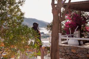 a woman standing on a balcony looking out at a valley at Skopelitis Village in Katapola
