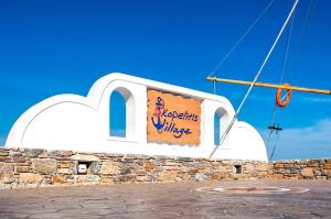 a sign on the side of a building at Skopelitis Village in Katapola