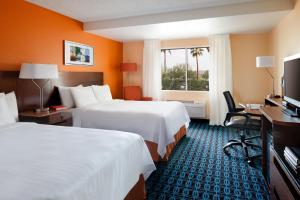 a hotel room with two beds and a flat screen tv at Country Inn & Suites by Radisson, Phoenix Airport, AZ in Phoenix
