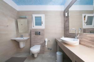 a bathroom with a toilet and a sink at Skopelitis Village in Katapola